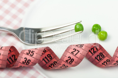 plate with peas and centimeter measure