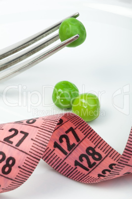 plate with peas and centimeter measure