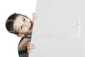 little boy holding a whiteboard