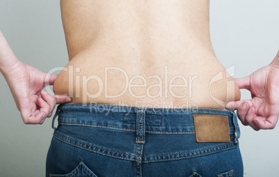 woman pinching fat from her waist
