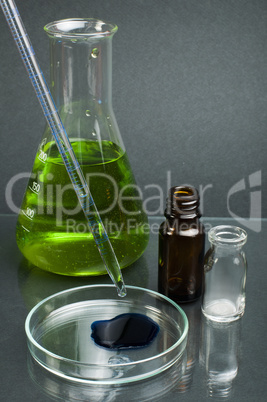 laboratory beaker filled with green color liquid substances