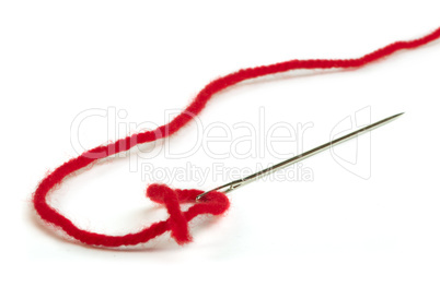sewing needle and red thread