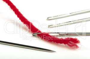 sewing needles and red thread