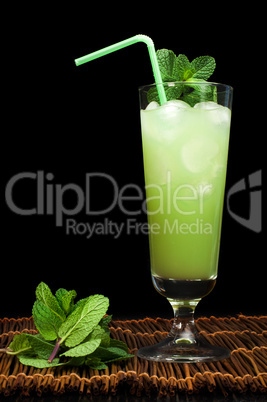 green cocktail with cubes ice