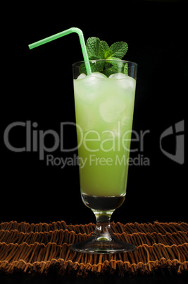 green cocktail with cubes ice