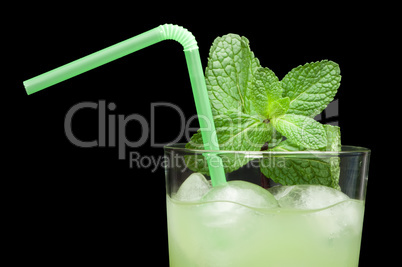 green cocktail with cubes ice