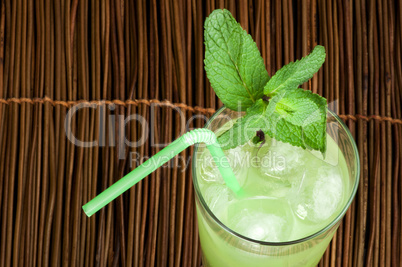 green cocktail with cubes ice