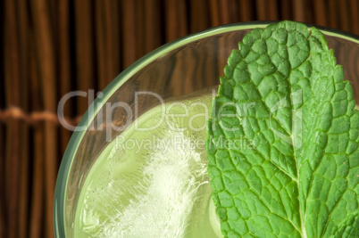 green cocktail with cubes ice