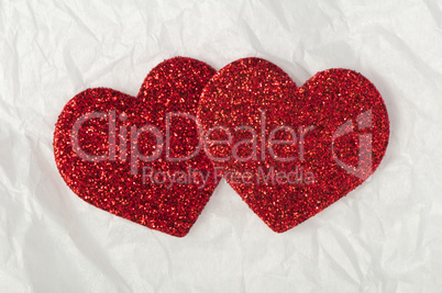 shiny red hearts on white paper