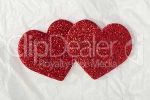 shiny red hearts on white paper