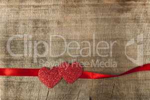 red ribbon tape and two hearts
