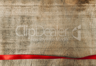 red ribbon for gift wrap on wooden background