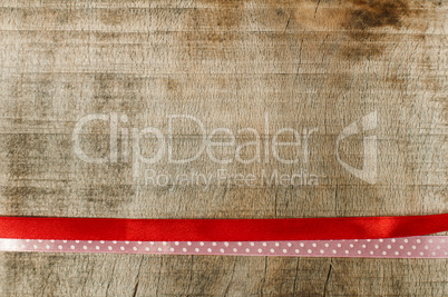 red ribbon for gift wrap on wooden background
