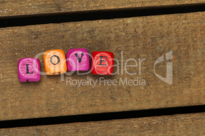 word love on multicolored wooden cubes on wood