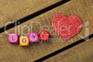 word love on multicolored wooden cubes on wooden background