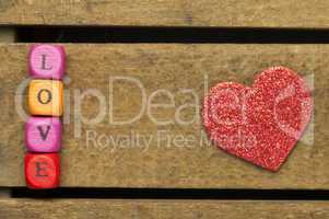 word love on multicolored wooden cubes on wooden background