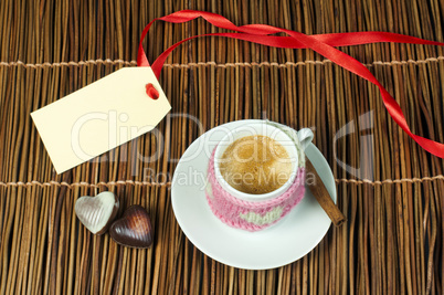 cup of coffee with knitted heart symbol