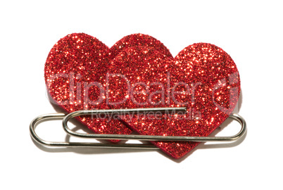 two red hearts attached with a paper clip