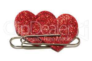 two red hearts attached with a paper clip