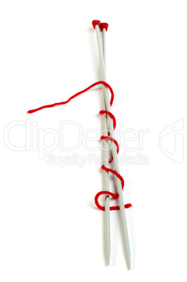 knitting skewers and red yarn