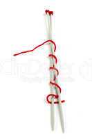 knitting skewers and red yarn