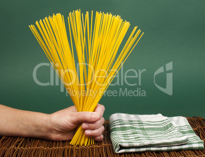 female hand holding spaghetti