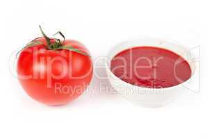 tomato and bowl of tomato sauce