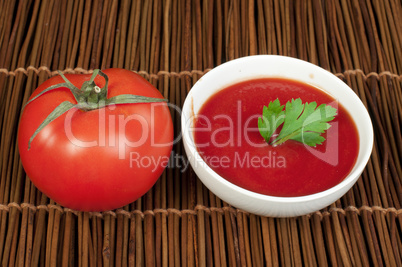 tomato and bowl of tomato sauce