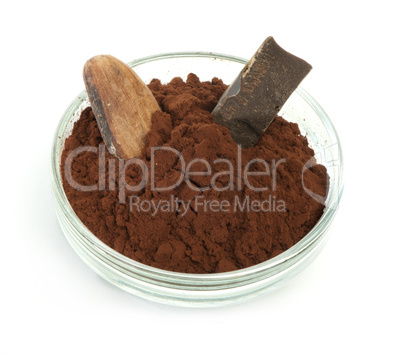 cocoa bean, cocoa powder in bowls and piece of chocolate