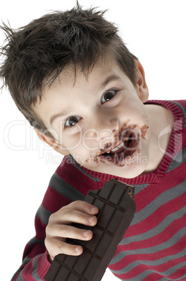 smiling little boy eating chocolate