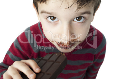 smiling little boy eating chocolate