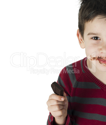 smiling little boy eating chocolate