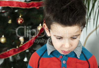 unhappy little boy on christmass