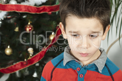 unhappy little boy on christmass