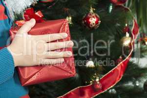 children's hands holding christmas gift