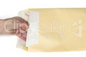 hand that open a letter from brown envelope