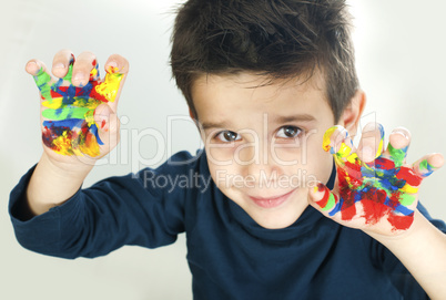 boy hands painted with colorful paint