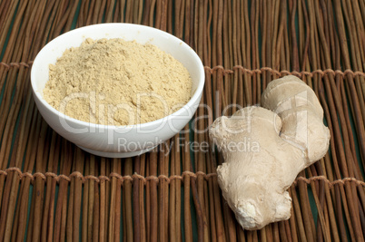 powdered ginger in a bowl and whole ginger
