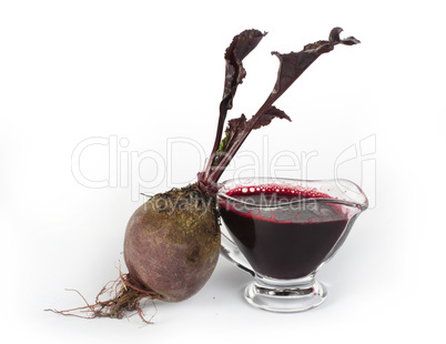 red beets with leaves and jug with juice