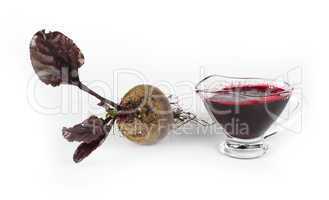 red beets with leaves and jug with juice