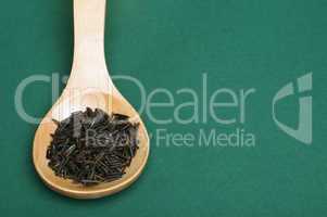 wild black rice in wooden spoon