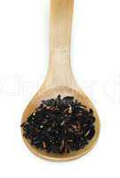 black rice in wooden spoon