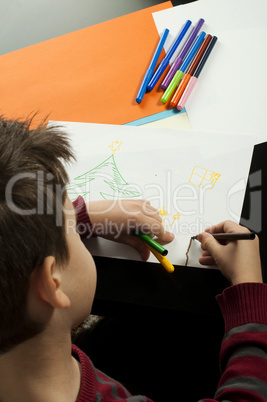 boy drawing with markers