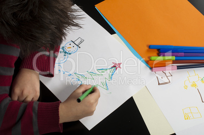 boy drawing with markers