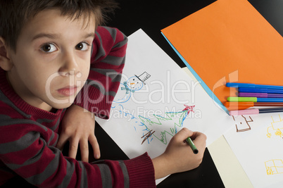 boy drawing with markers