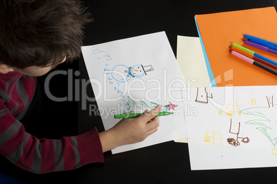 boy drawing with markers