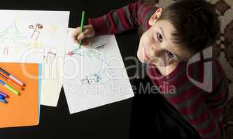 boy drawing with markers