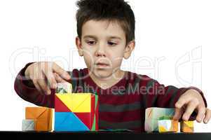 boy playing with multicolored cubes