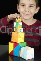 boy playing with multicolored cubes