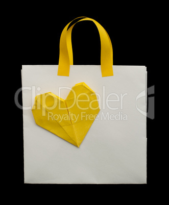 white shopping bag with yellow heart.